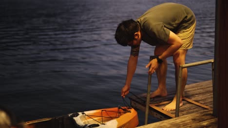 person preparing and launching a kayak