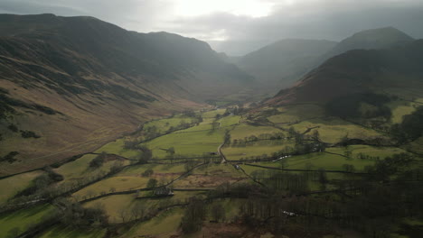 High-altitude-view-of-valley-surrounded-by-mountains-with-stormy-sky-in-English-Lake-District-UK