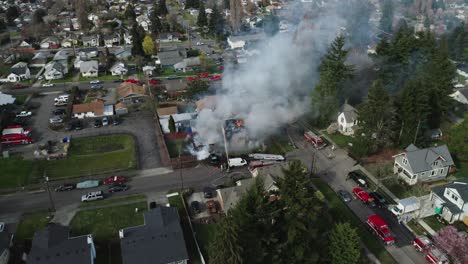 smoke billows from burning house in daylight