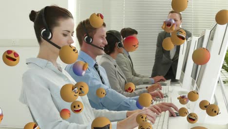 Animation-of-emoji-falling-over-business-people-wearing-phone-headsets