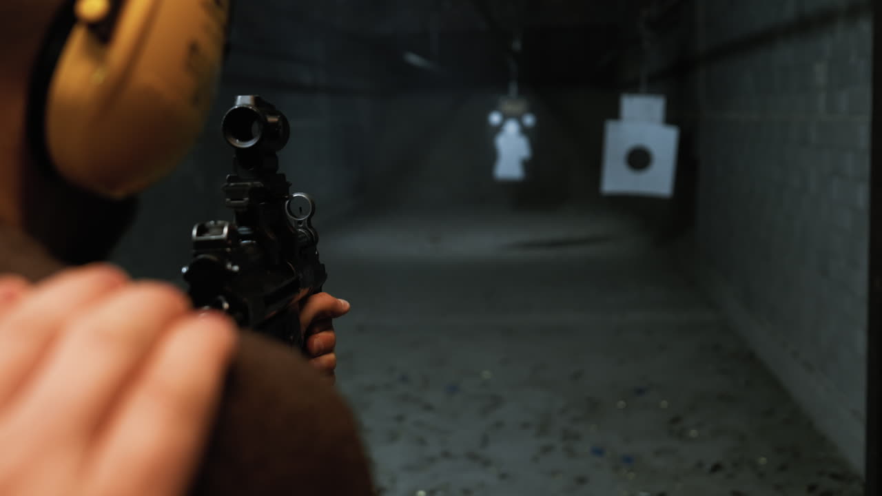 A person firing an MP5 submachine gun in bursts at a shooting range. Ideal for firearms, tactical training, military, law enforcement, and weaponry stock footage