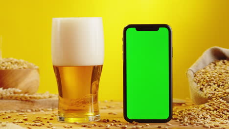 beer and smartphone with green screen