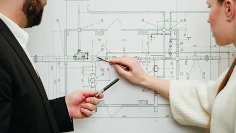 professionals collaborating on a technical blueprint