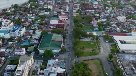 Hyperlapse of bustling streets and rooftops along the downtown island province Virac, Catanduanes, Philippines - aerial forward shot