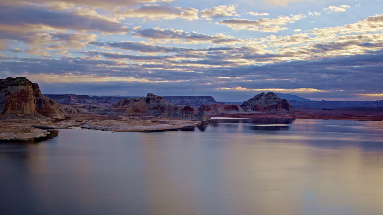 Drone soaring toward captivating rock formations close to Lake Powell in Page, Arizona.