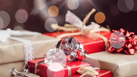animation of falling spots of lights over christmas gifts