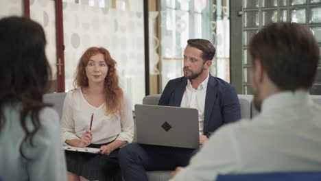 business meeting between two women and two men at an office