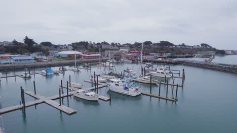Aerial-reverse-dolly-around-nearly-empty-harbor-in-Bandon-Oregon
