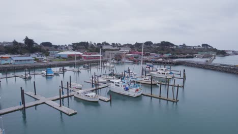 aerial reverse dolly around nearly empty harbor in bandon oregon