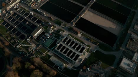 Dolly-back-pan-up-reveal-shot-of-large-water-treatment-plant