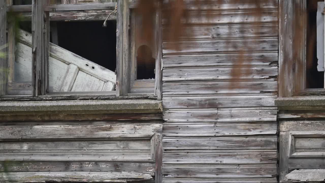 Abandoned Wooden House with Broken Windows