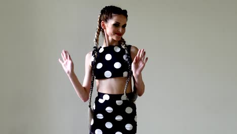 portrait of a beautiful woman in a dress with long pigtails