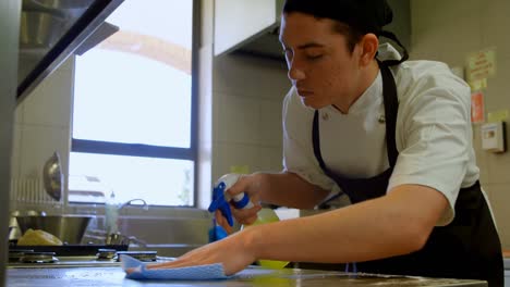 male chef cleaning worktop in kitchen 4k