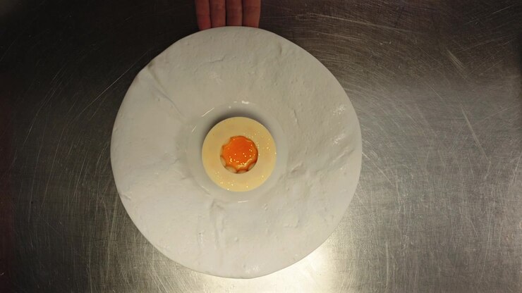 Top Down View of Hazelnut, White Chocolate Passion Fruit Dessert on White Dish