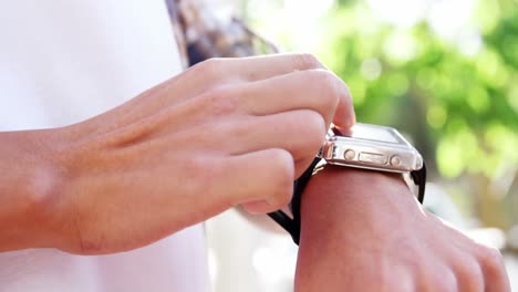 close-up of hand tapping on smartwatch