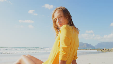side view of young caucasian woman relaxing on the beach 4k
