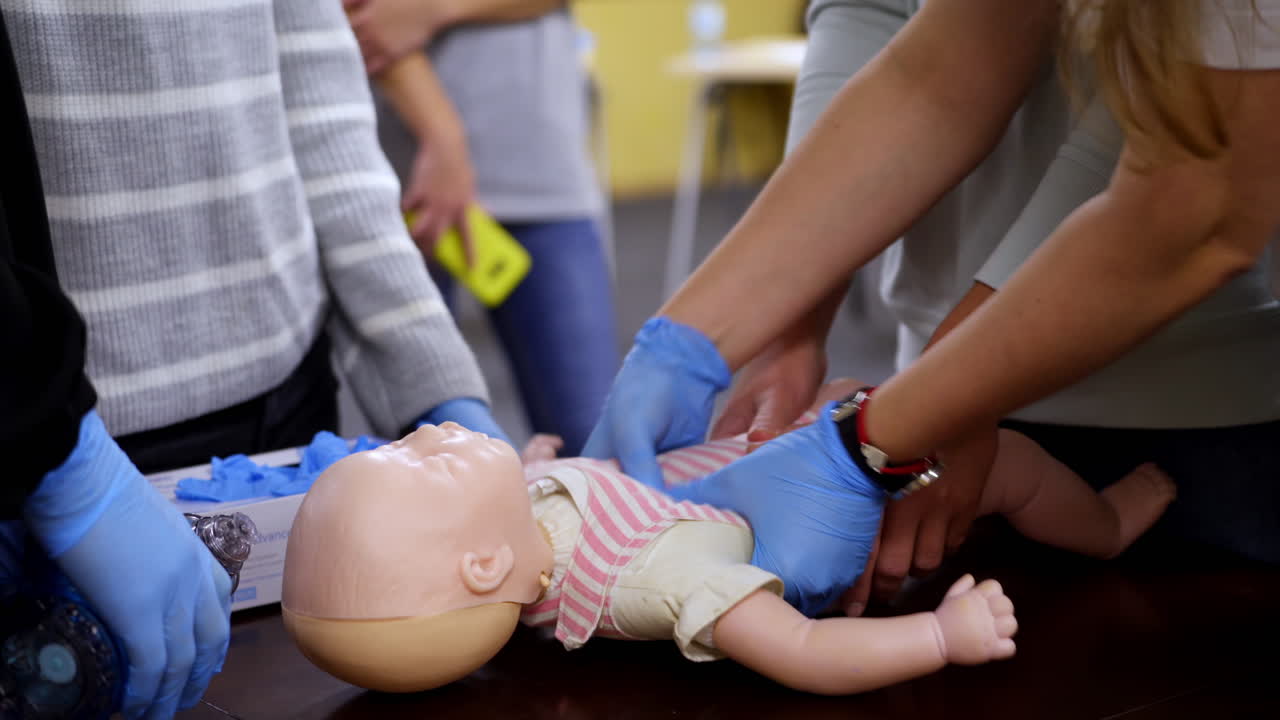 Newborn resuscitation on an infant dummy doll. First help medical class. Healthcare and education.