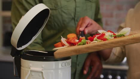 senior african american husband and mixed race wife cooking together at home