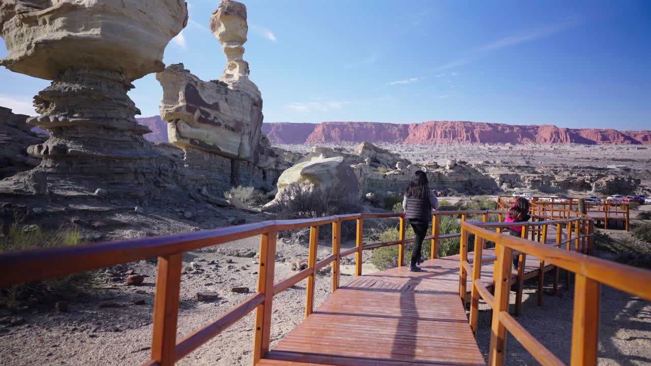 Mother and Daughter Walk at Ischigualasto Valley of the Moon Landscape, San Juan Argentina