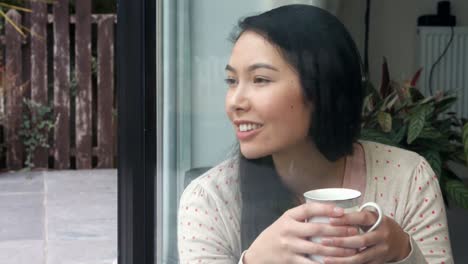 pretty young woman looking out the window