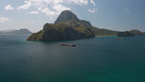 Aerial-of-a-cargo-boat-in-front-of-Maligaya,-El-Nido,-Palawan,-Pilippines