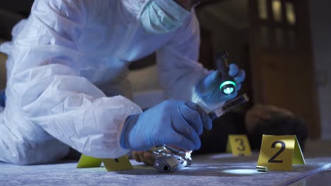 Forensic-expert-conducting-forensic-investigation-at-crime-scene.