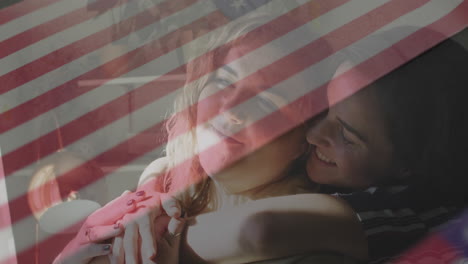 female couple hugging on sofa, showing marketing concept with animated heart icon and flag overlay