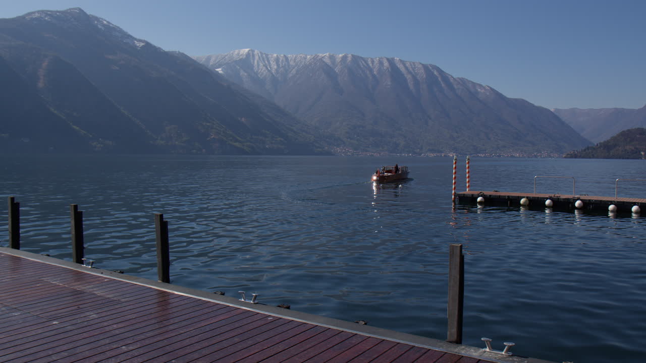 Boat Leaving Marina By The Lake Como In Summer In Tremezzo, Lombardy, Italy, Wide shot