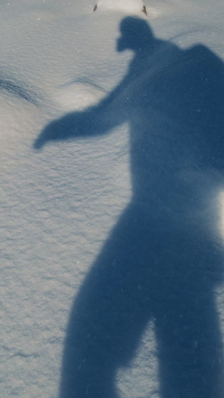 Silhouette cast on fresh snow during a winter hike in the mountains