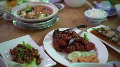 chinese round table meal in restaurant gungpao chickend and tofu clay pot