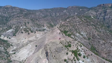 aerial pull back shot of a cable car in the urique canyon in divisadero, copper canyon region, chihuahua