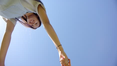 holding hands, two people bonding under clear blue sky, enjoying togetherness, copy space