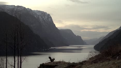 off season winter timelapse from morning to day in remote veafjord, passing clouds and dark hillsides