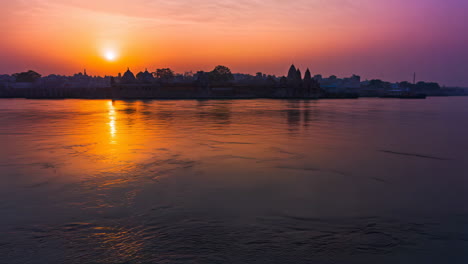 vibrant sunset over a holy river with ancient temples