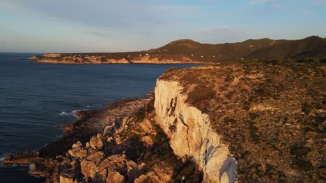 Drone-view-of-the-cliffs-and-the-beach-of-Ibiza,-Spain