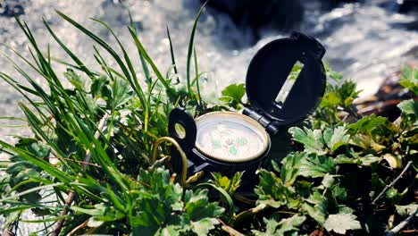 compass on the grass near litle stream
