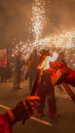 barcelona, spain - 22 september 2023 : crowds in the street for the fire run or correfoc, during la merce festival, barcelona spain in vertical