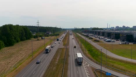 Cars-driving-on-A1-highway-road-near-Kaunas-city,-aerial-view