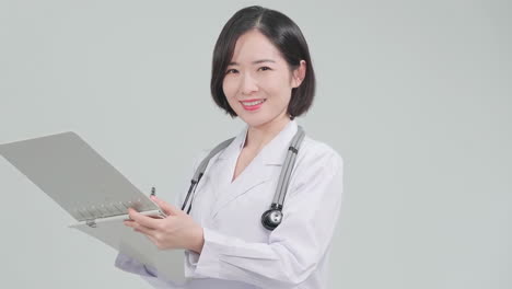 therapist, female doctor pharmacist nurse smiling wear white uniform with a folder standing in hospital office