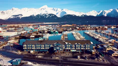 4K-Drone-Video-of-Seward-Boat-Harbor-and-Surrounding-Snow-Covered-Mountains-on-Snowy-Winter-Day-in-Alaska