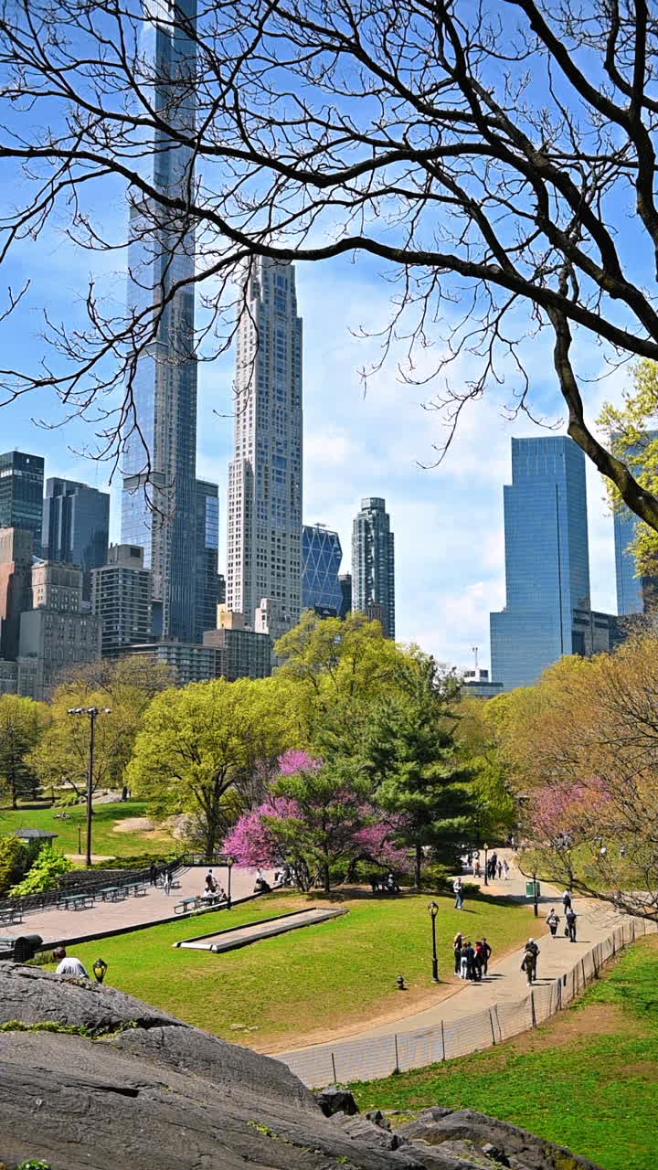 Spring path in Central Park with tall Manhattan buildings