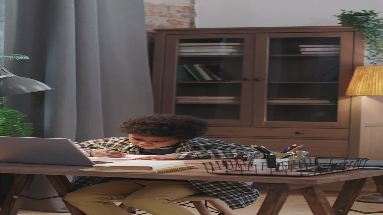 Father Helping 8-Year-Old Son With Homework