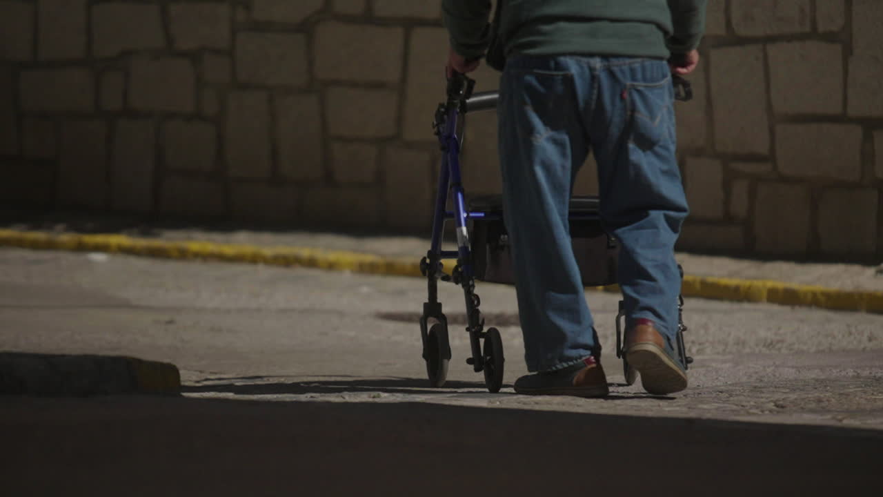 Elderly Man Walking with Walker at Night