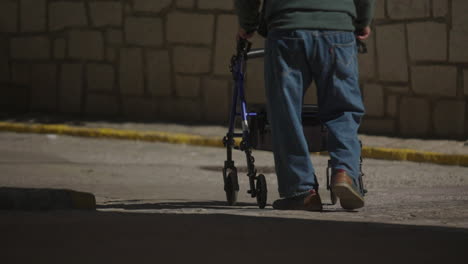 elderly man walking with walker at night
