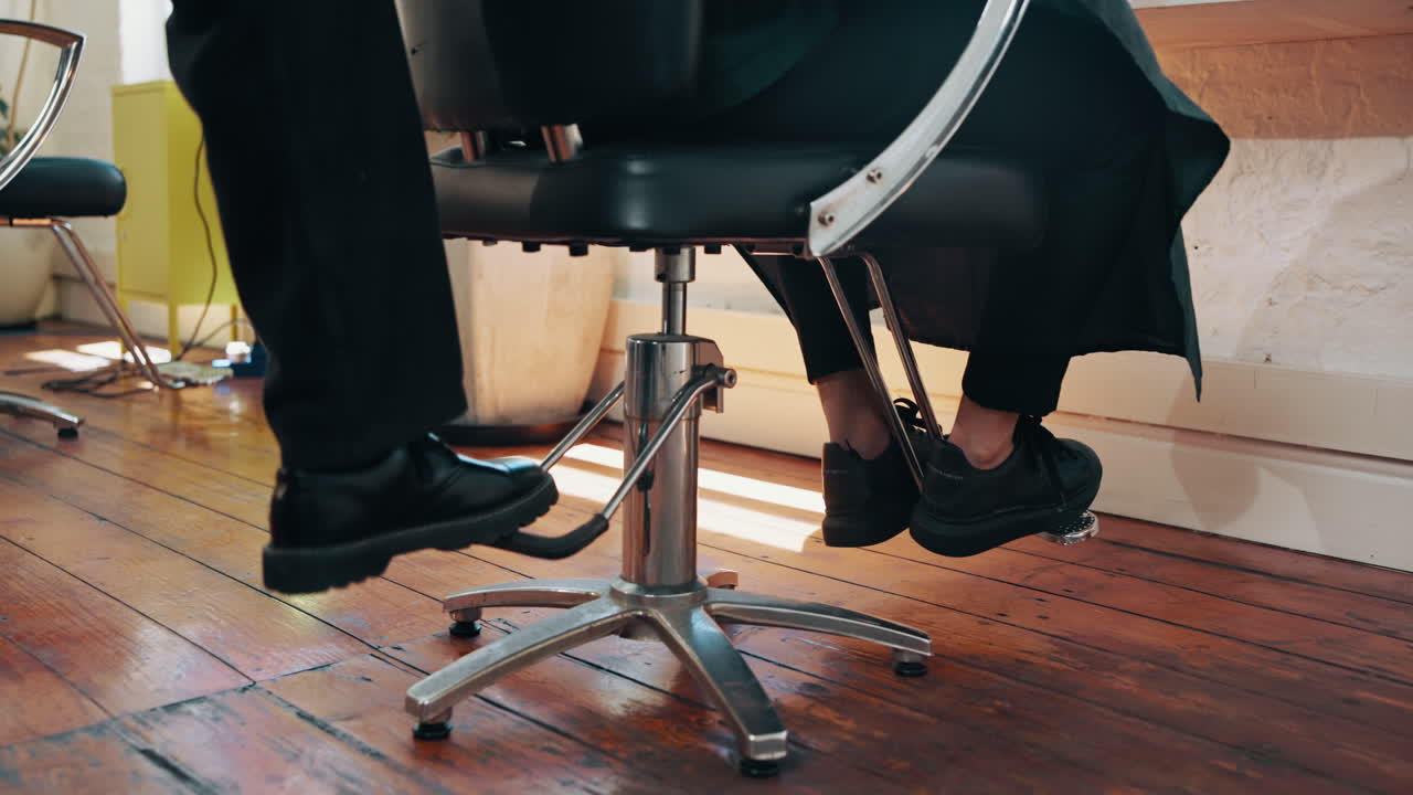 Close Up of Client's Feet on a Barber Chair Footrest