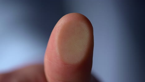 Marco-video-of-fingerprint-on-glass-surface-indoors.Man-thumbprint-on-windowpane