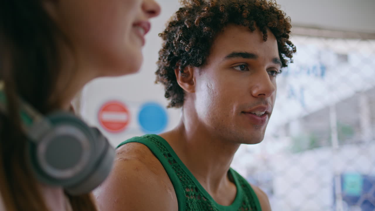 Closeup teenage couple talking in urban cafe. Handsome  guy chatting