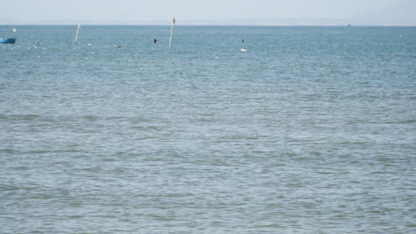 Fishing-net-locations-marked-with-flags-in-ocean-water-near-coast-of-Vietnam