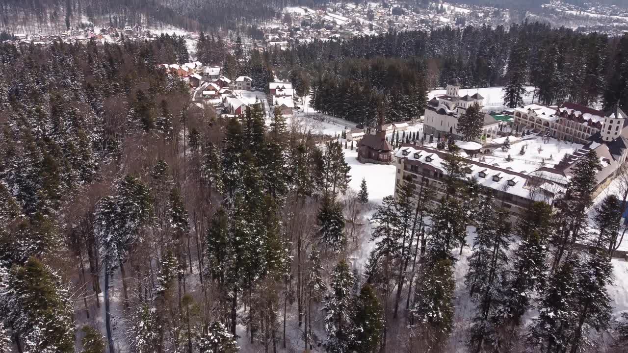Flying Over Pine Trees In A Mountain Range Reveal Church