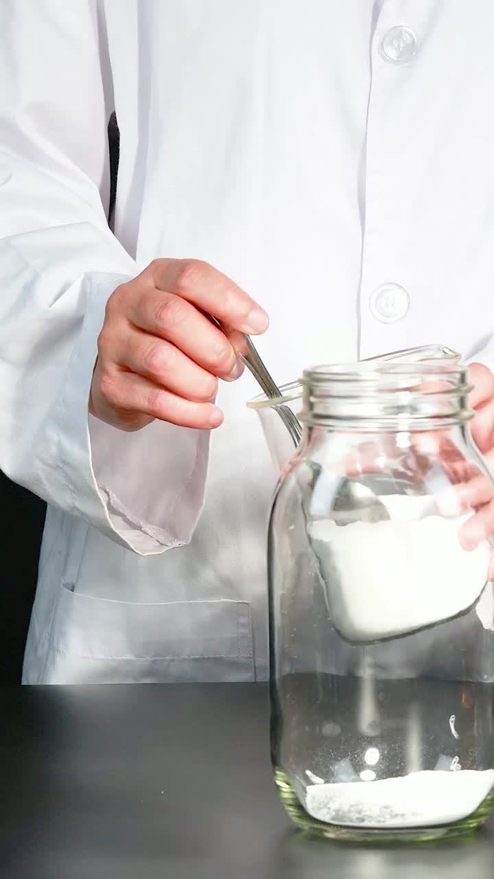 A step-by-step demonstration of creating a homemade lava lamp using oil, water, and dye in a laboratory setting